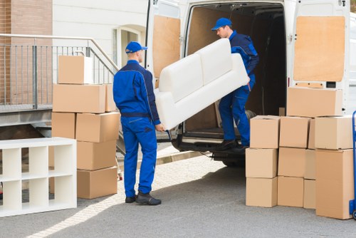 Furniture pick-up team removing a sofa from a Southgate home