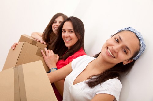 Local movers planning a packing service with labelled boxes