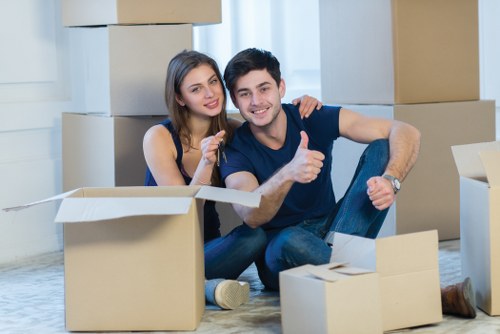 Removalists handling bulky items at a Southgate property