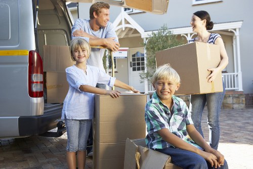 Packed boxes and household items being loaded into a van